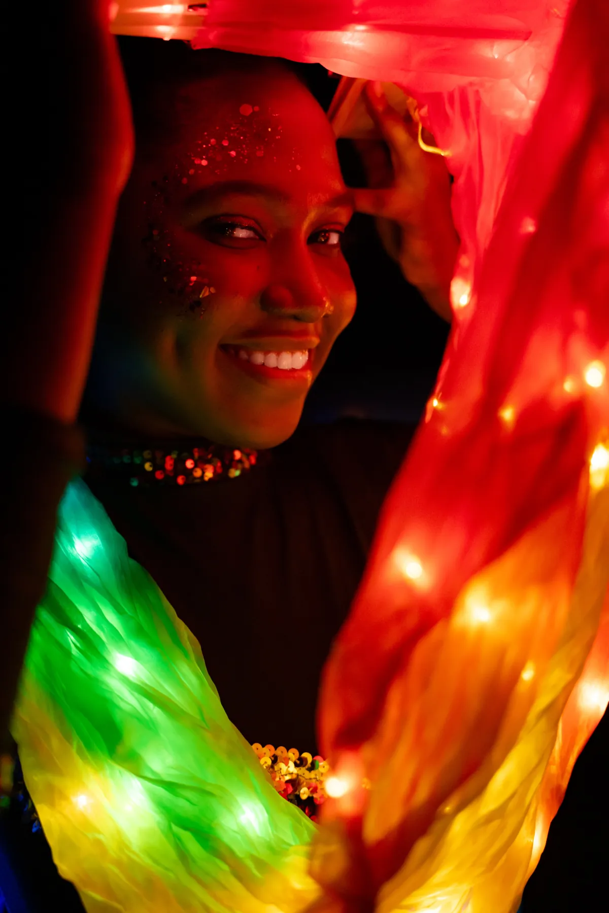 LED costume performer with glowing rainbow lights